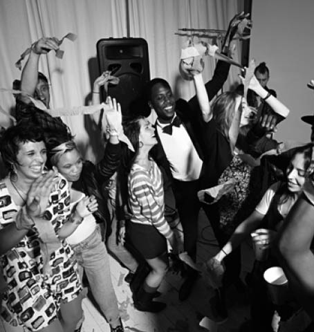 People dancing at party with streamers