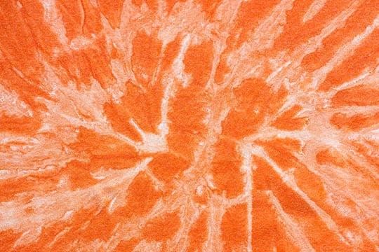 orange abstract pattern handcrafted in batik technique on cotton jersey fabric