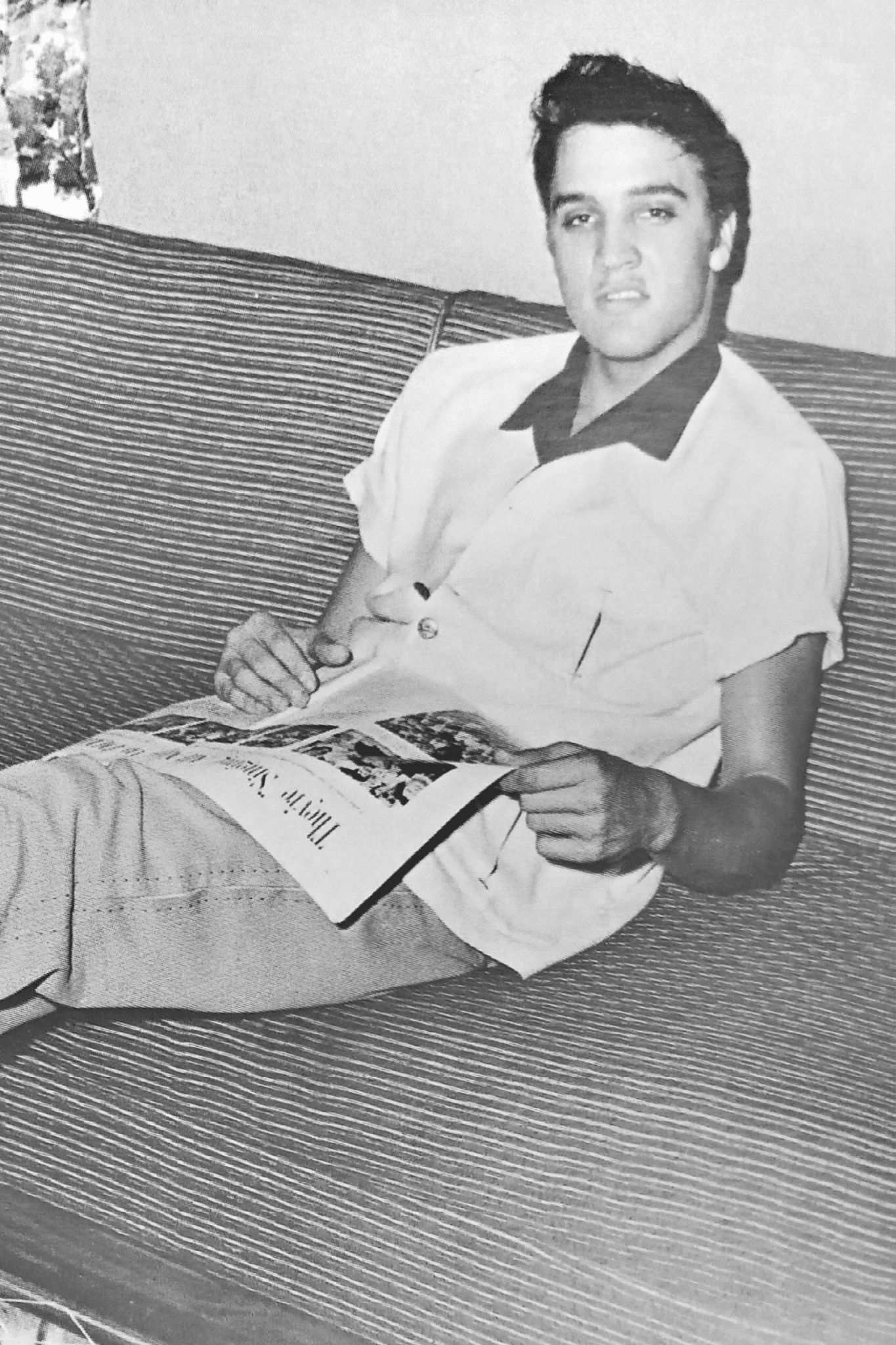 Cirebon, Indonesia. 01.26.2024. Black and white photo of famous musician Elvis Presley relaxing at his Audubon home, mid-50s, taken from the August 2005 issue of Rolling Stone Indonesia magazine.