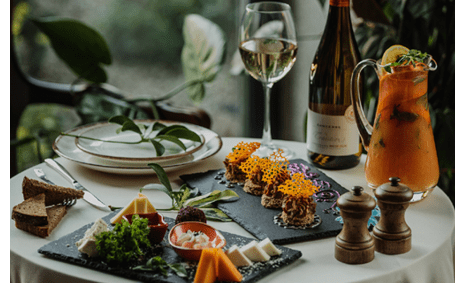 side view of a table with cheese plate and pate on it