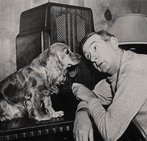 Man and dog listening to the radio
