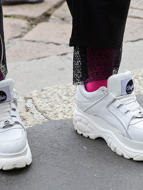 MILAN, ITALY - JANUARY 12, 2019: Man with white Buffalo shoes and pink socks before Frankie Morello fashion show, Milan Fashion Week street style 