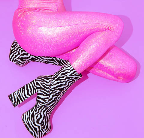 Fashion Party Girl in pink glitter leggins and zebra boots. Club Disco style 90s. Minimal concept